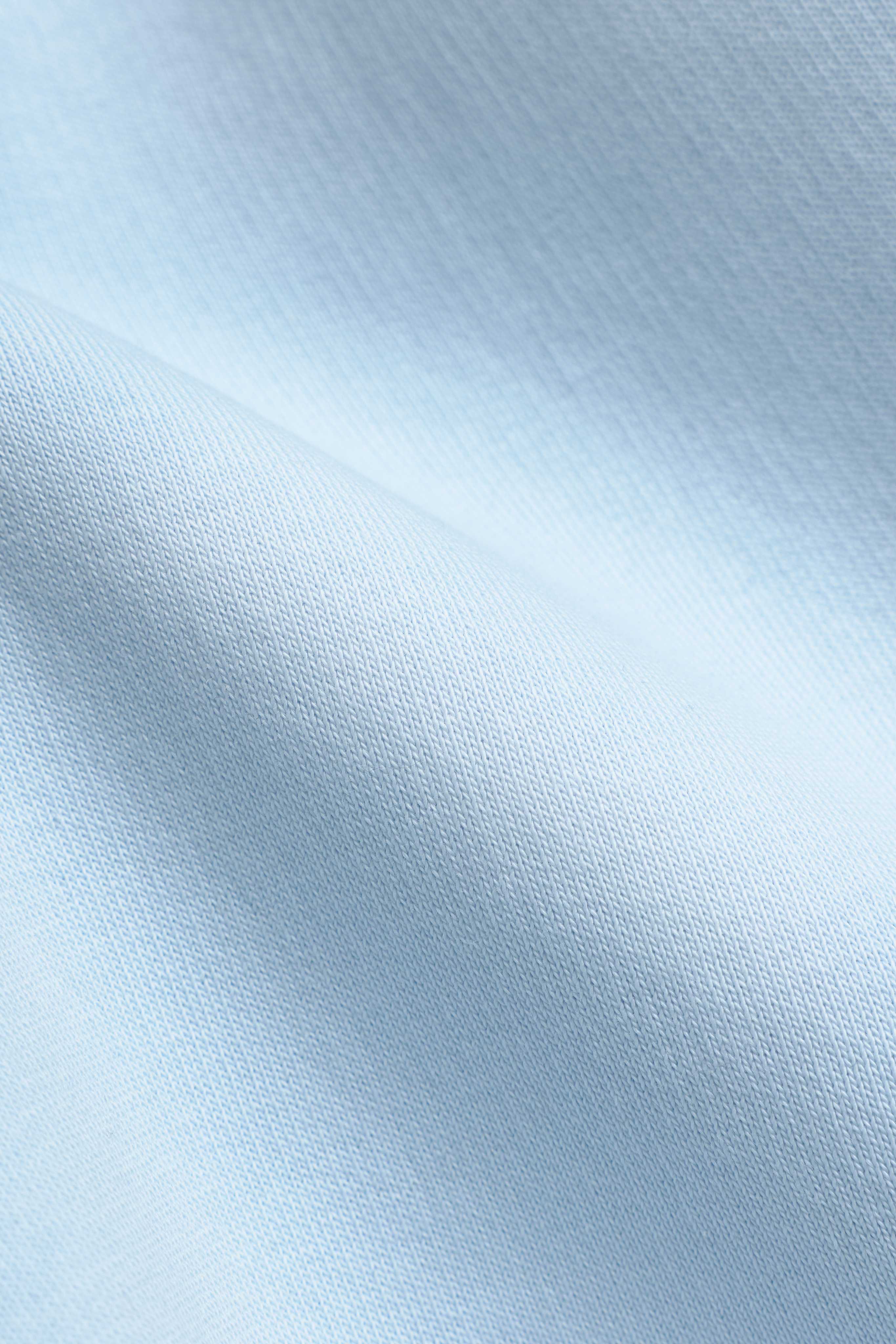 Close-up of baby blue Pima cotton fabric texture on CASPARA Pollux shorts.